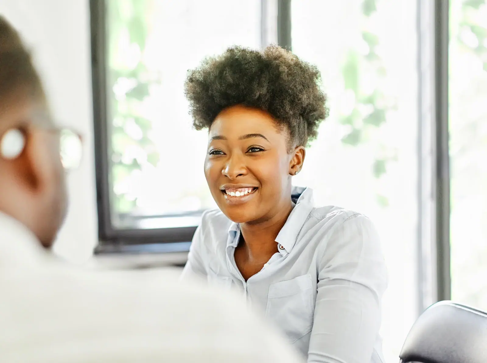 Smiling woman talking with a man during an office meeting