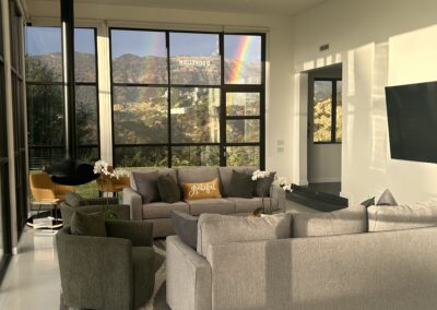 A luxurious living room with a large window showcasing breathtaking mountain views