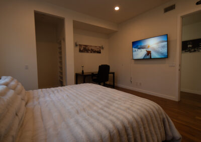 Image of a bed with a white comforter in a luxurious setting at a drug rehab facility in Los Angeles