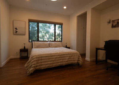 White comforter on a bed in a luxurious room at a drug rehab center in Los Angeles